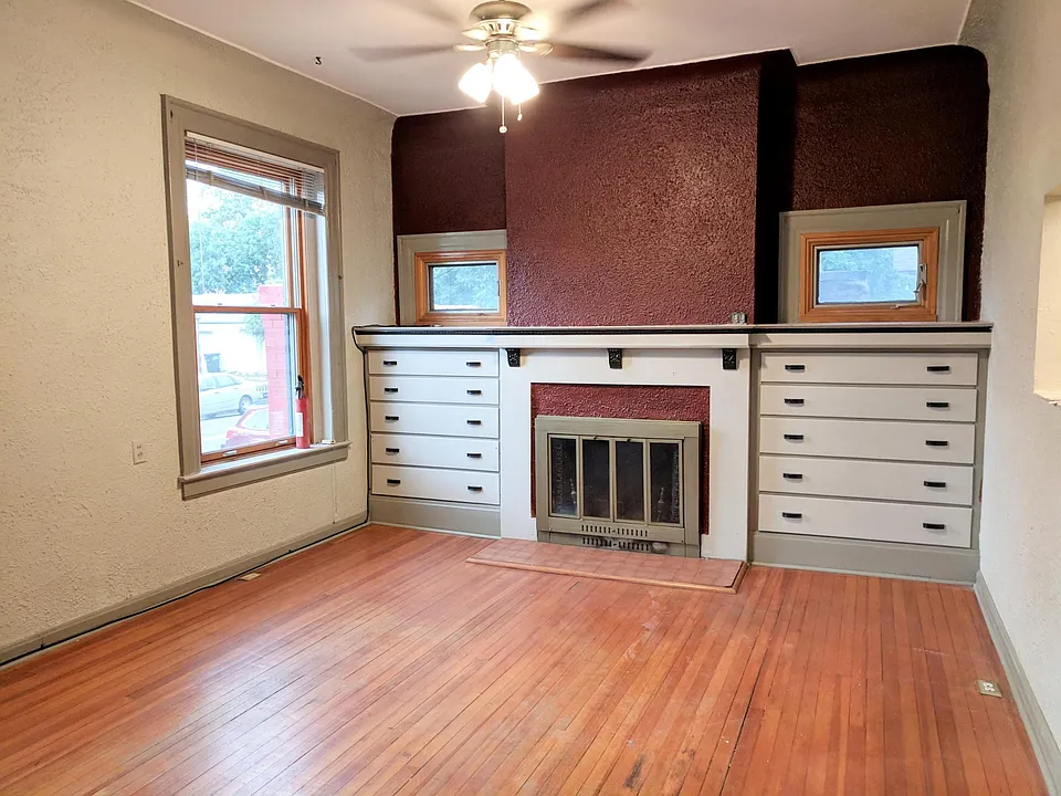 Living room with built ins. Fireplace not functional