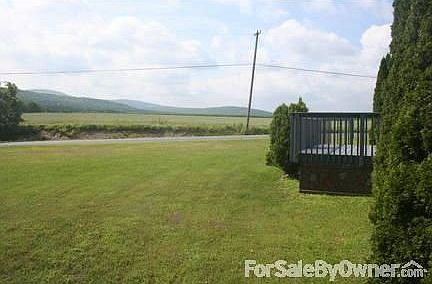Views of neighboring farm fields and mountains.