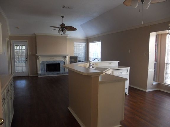 Second living area with gas fireplace attached to kitchen.