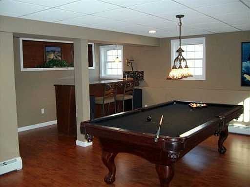 Exceptionally designed walkout family/pool room w/wetbar & gym room.
