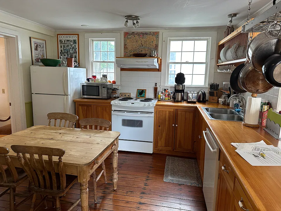Another view of the Kitchen with the door to the Back Bedroom far left. The scrubbed pine kitchen table is period English, like so much of the furniture.