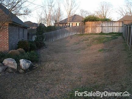 Yard on right side of home.
						:
						There are pomogranates, blueberries, blackberries, grapes, and figs grown here.