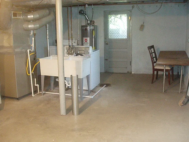 back of basement, laundry area and gas furnace and AC as well as back door. furniture and table do stay with property for assistance with laundry and folding.