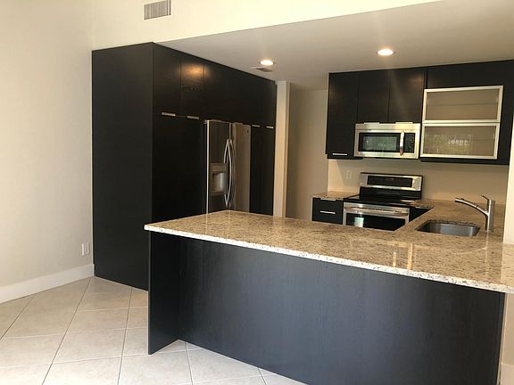 Kitchen- granite countertops, stainless steel appliances and a ton of storage.