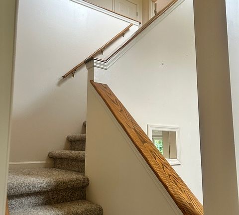 Stairs from entry to upstairs bedrooms