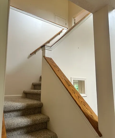 Stairs from entry to upstairs bedrooms