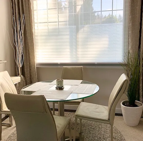 High-end leather dining chairs paired with a modern glass table