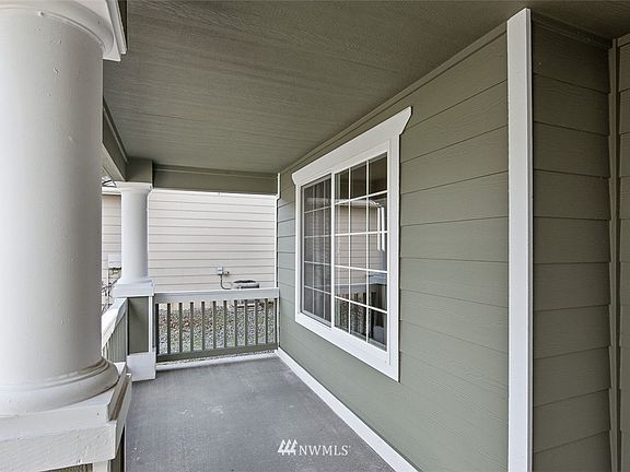 Cozy seating area on the front porch. Hang a swing? Place chairs and side table?