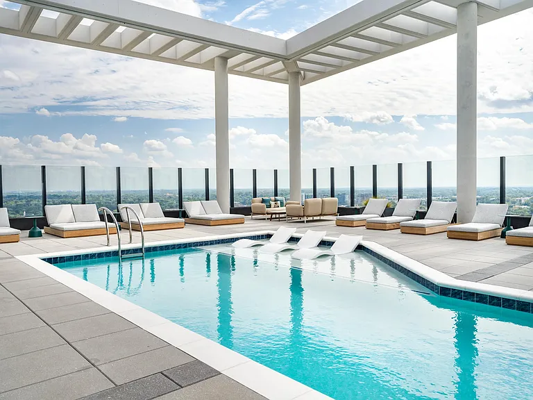 Modera Parkside's rooftop pool with in-water loungers and open-air seating offers a relaxed escape, overlooking Atlanta.