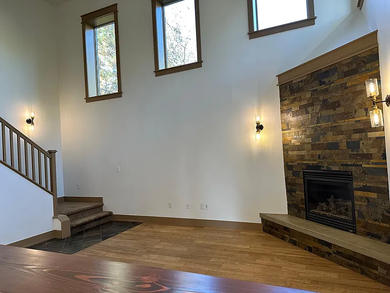 View of living room and stairs from kitchen