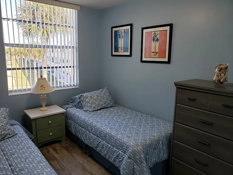 BR2 with 2 twin long beds, dresser, nightstand and closet.