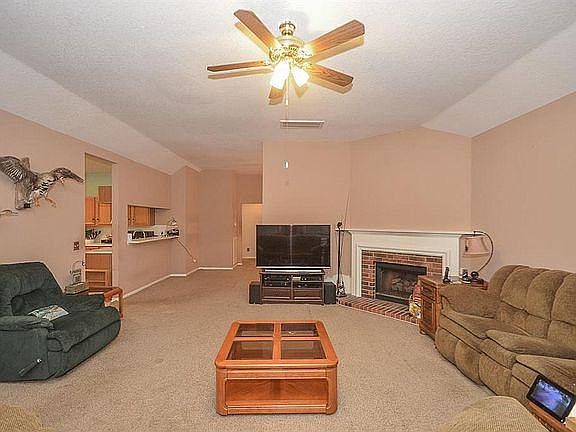 High ceiling living room with log gas fireplace