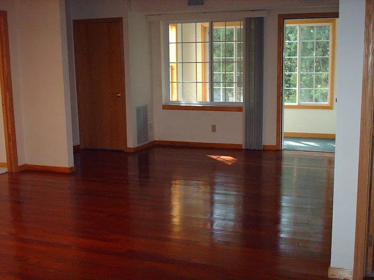 Living room with hardwood floor and 3 season porch