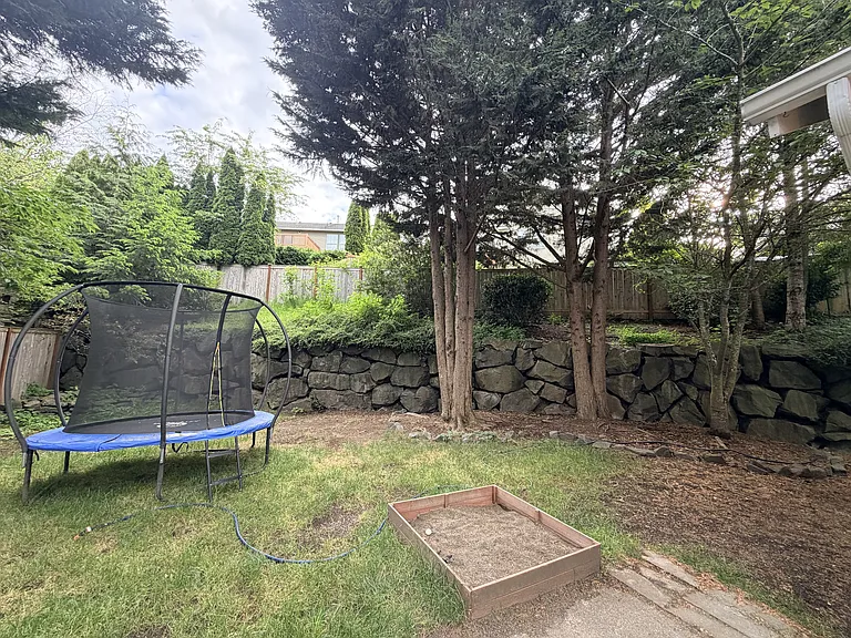 Big backyard with retaining wall. Ample room to run around and play. Fenced off in 2 sections.