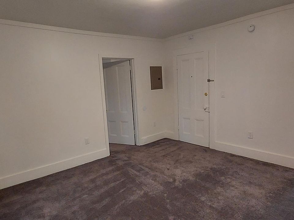 View from the living room NW corner toward the bedroom, entry and kitchen access.