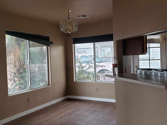 Dining Area with Lrg Picture windows on 2 walls. Kitchen is visible on right