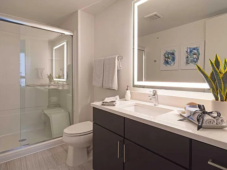 Washrooms feature framed, lighted mirrors, sit down shower, and built-in shower shelving.