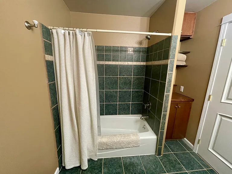 Shared bathroom with one other bedroom. Storage next to the shower...