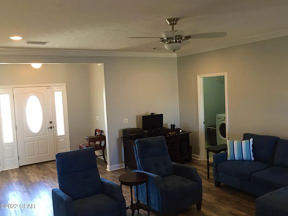 Living room, with laundry room in the corner that connects to garage