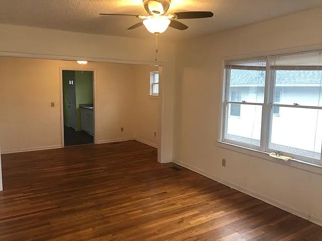 From the front door looking through the living room and dining room unfurnished.