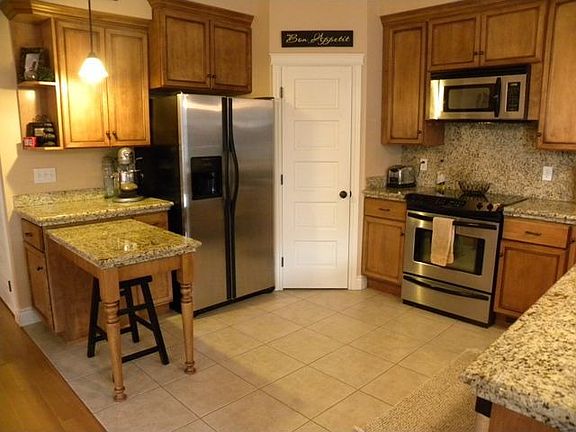 Kitchen w/ Granite Counters, Ceramic Tile Floor, Stainless Appliances & Pantry
