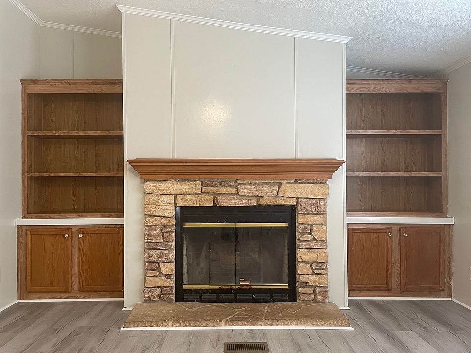 Wood burning fire place and built in cabinets and shelves