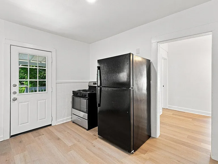 Kitchen area with light wood-finish flooring