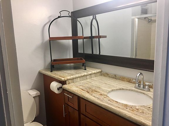 Remodeled bathroom w/ granite vanity and cherry wood cabinet