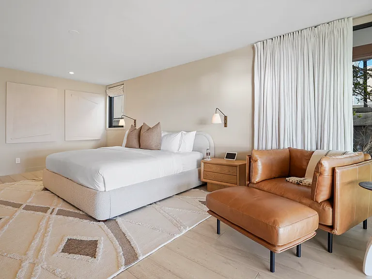 Slip into relaxation with dimmable lighting and room-darkening shades.