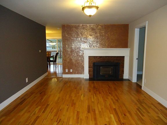 The huge living room offers a cozy fireplace and hardwood floors. The entire home was just newly painted and the bedrooms have new carpet.