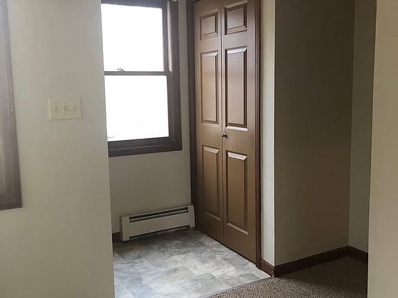 Entrance to house with coat closet, tile 
floor