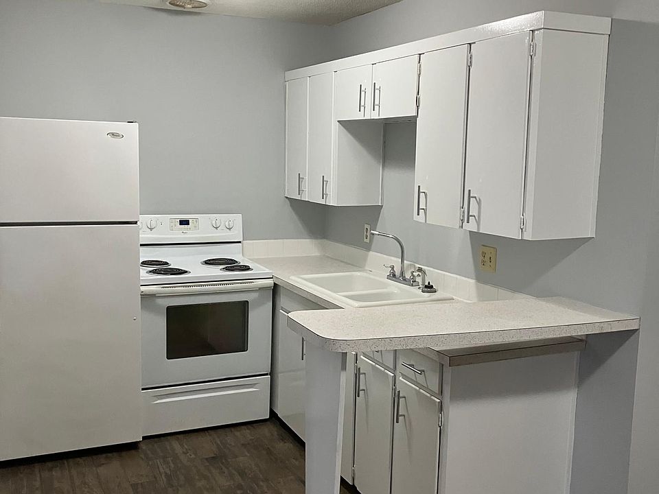 Kitchen with range and refrigerator