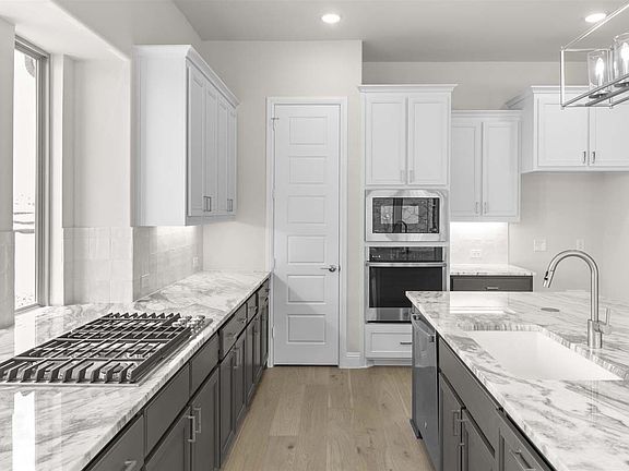 Larue floor plan by Pacesetter Homes featuring two-story living with open family and dining spaces,