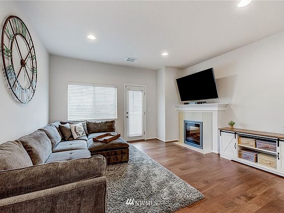 Spacious living room with fireplace and entrance to balcony