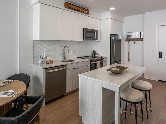 White flat front cabinetry and an open concept kitchen