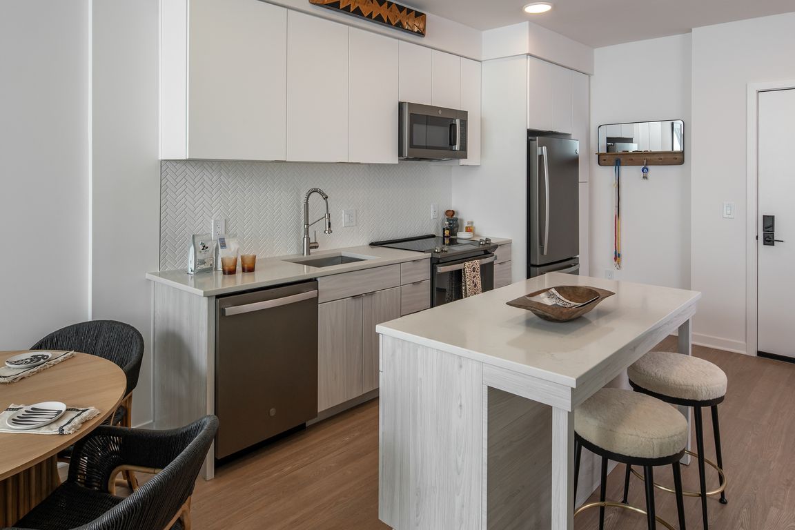 White flat front cabinetry and an open concept kitchen