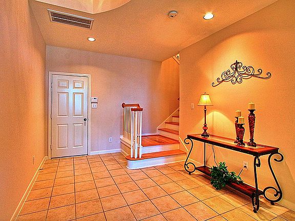This view of the foyer looks towards the entry door from the garage and the entry to the staircase.