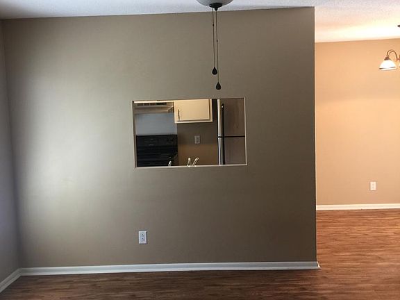 bright and airy living room with kitchen access
