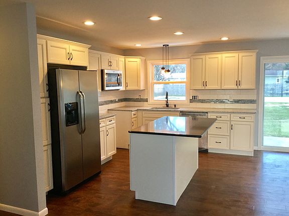 Brand new kitchen with stainless appliances, quartz countertops, separate island, and gorgeous backsplash.  You'll love the amount of cabinetry and storage for the busy family.