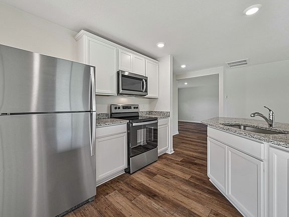 The kitchen is chef-ready with stainless steel appliances