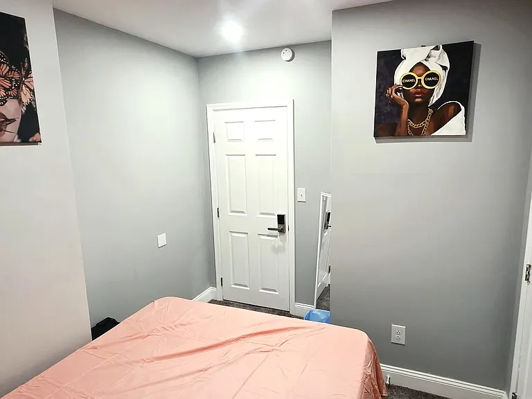 Private bedroom with neutral walls, soft carpeting, and space for a full bed, plus easy access to nearby storage/closet.