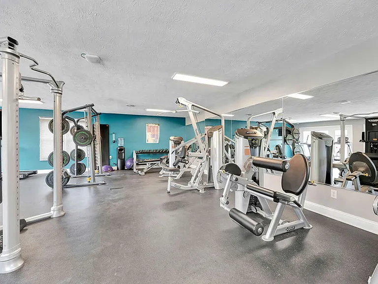Fitness Center with Running Machine, Stair Stepper, and Cycling Machine at The Commons Student Apartments in Oxford, OH