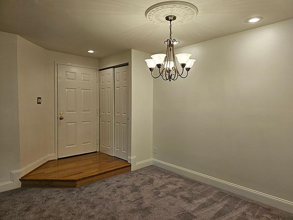 Chandelier, wooden step in, coat closet and double locked fire door.