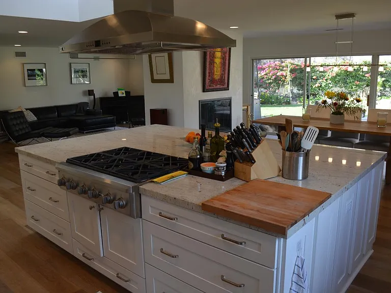 View of the kitchen, dinning and leaving room separated by the fireplace. View of the back yard.