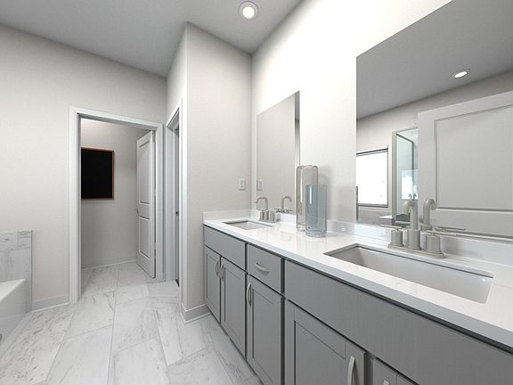 The primary bathroom offers dual vanity sinks and a walk-in shower.