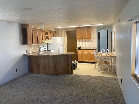 Full view of the kitchen/dining room. The door on the right leads to the master bedroom