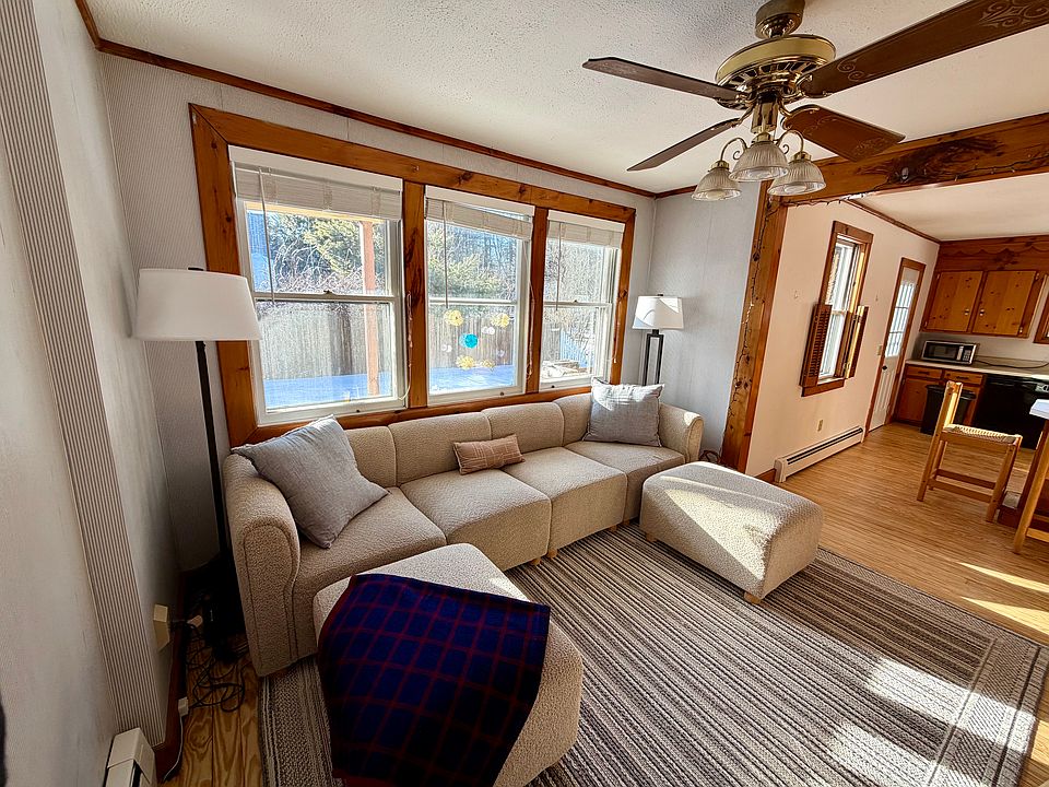 living area with large couch and ottomans