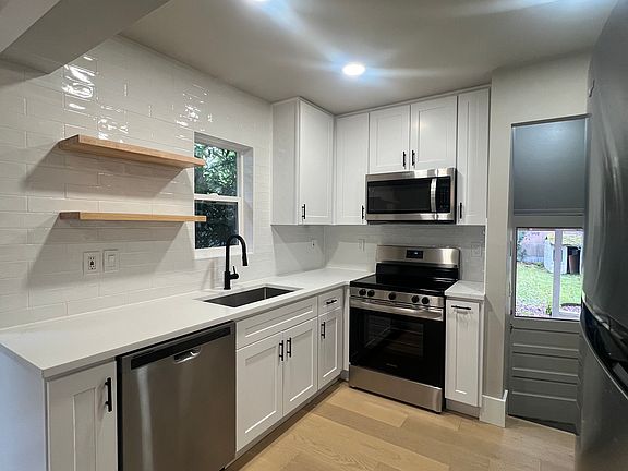 Kitchen has access direct access to fenced backyard
