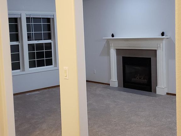 Front room viewed from entry. Note gas fireplace.