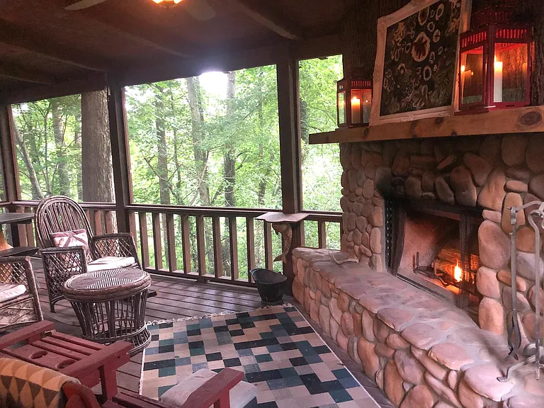 Fabulous screened-in porch overlooks trees in natural setting.
